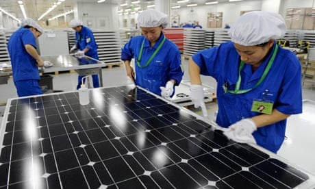 China solar industry : Employees inspect solar panels at a workshop in factory in Hangzhou