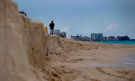 COP16 Cancun : A man stands on a eroded beach