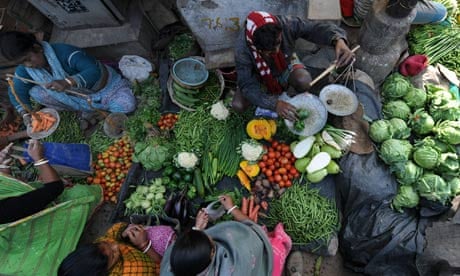 Indian vegetable vendors attend to clien