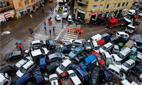 IPCC and extreme weather : Cars overturned torrential rains are seen on a street in Genoa, Italy