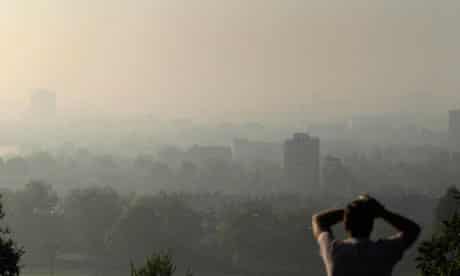 Air pollution in UK : smog covering central London from Parliament Hill