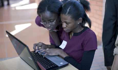 MDG : Social networking in Africa : Two unidentified African students work on a laptop 