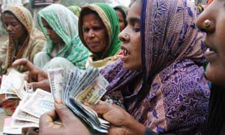 MDG : Microfinace : Bangladeshi Women Count Money or repayment to a microcredit bank