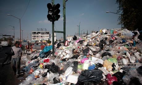 Garbage and landfilll in Mexico city : People walk past piled up rubbish in downtown Mexico City
