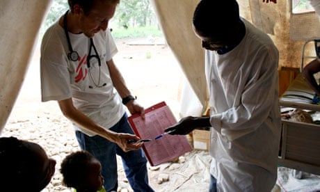 MDG: Dr Chris Bird (L) and a nurse show a mother a record of her child's weight gain, DRC