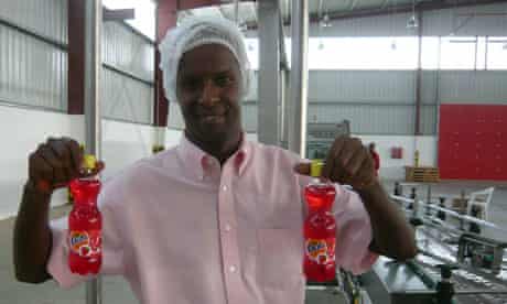 MDG : Mark in Somaliland : Moustapha Guelleh holds strawberry Fanta at Coka Cola plant
