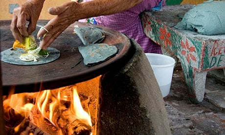 MDG : Woman cooking with blue corn tortillas and cheese in Oaxaca, Mexico