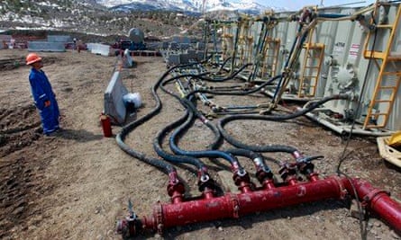 A worker helps monitor water pumping pressure for fracking (shale gas)