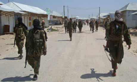 MDG : Somalia : Al-shabab recruits walk down a street 