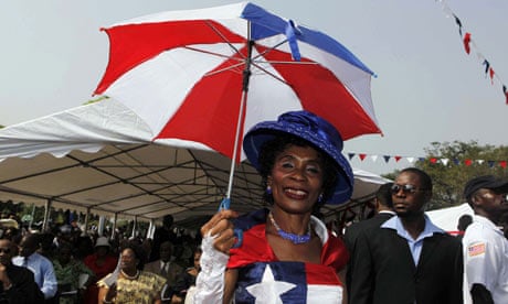 MDG : Liberia : A woman dressed in the colours of the Liberian national flag 