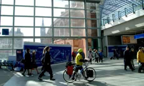 Bike blog : A cyclist pushes his bicycle through St Pancras station, Eurostar terrminal