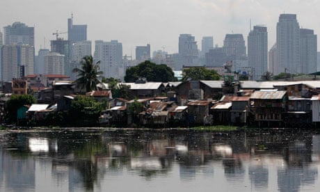 MDG : breaching inequalities : High-rise buildings in the background with slum  in Manila