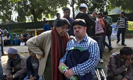 MDG: Shanti Auluck, centre, speaks to her son at a disabled rights rally in New Delhi, India