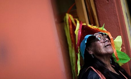 MDG: A former prostitute wears a piñata as a hat during Christmas celebrations in Mexico City