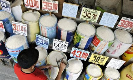 MDG : A shopkeeper displays different varieties of rice for sale at a market in Manila, Philippines