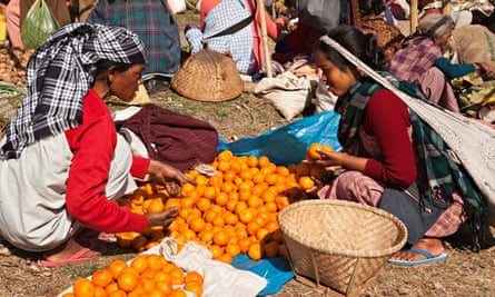MDG A woman sells oranges at a bazaar in Meghalaya