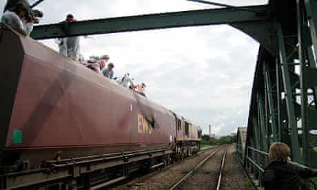 Activists halt a train on its way to Drax power station