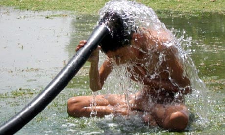 A Pakistani boy cools off in a park in Multan