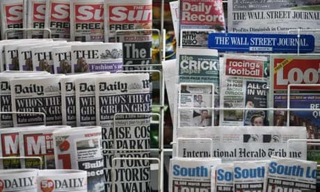 Newspapers are displayed outside a newsagent in London