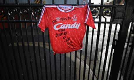 A Liverpool Football Club shirt is tied to the Shankly gates at Anfield stadium