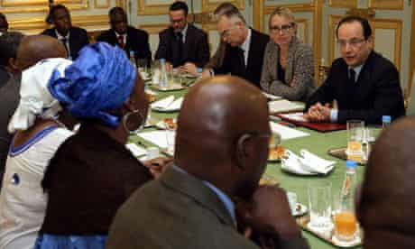 The French president, Francois Hollande, right, speaks with members of Malian associations in France