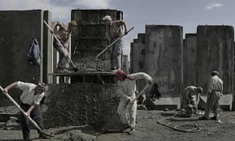 Afghan men work at a factory 