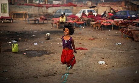 A girl plays next to a makeshift shelter in New Delhi, India