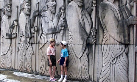 Two Parsi children chat outside a Zorastrian temple in Mumbai
