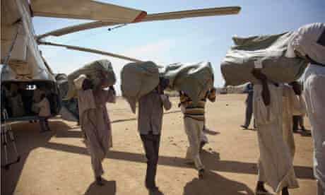 Volunteers unload humanitarian aid in Darfur