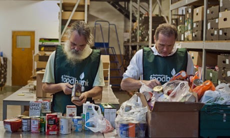 Volunteers sort through donations of food at a food bank
