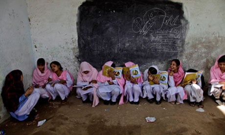 Pakistani schoolgirls attend class at a makeshift school near Lahore, Pakistan