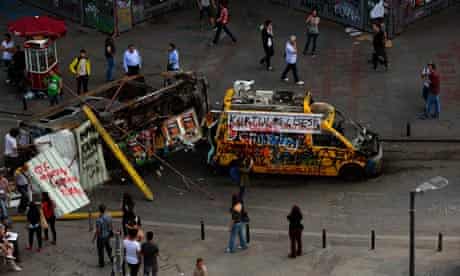 A damaged TV broadcasting van and a mini bus at Taksim Square