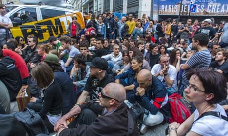 Activists and mourners sit at the location in Paris where Clément Méric was murdered