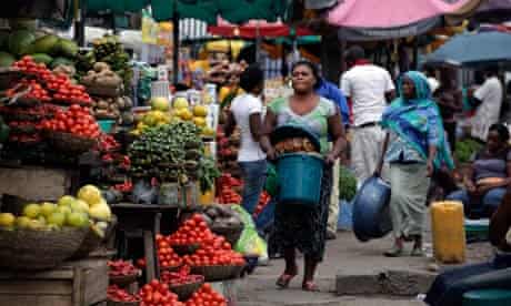 Women sell vegetables and other food in a market on World Food Day in Lagos, Nigeria