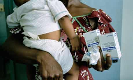 A mother holds her anti-retroviral drugs 