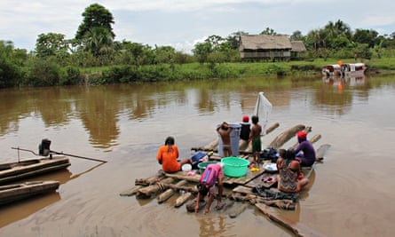 Kukama women and children doing washing in river  in Cuninico