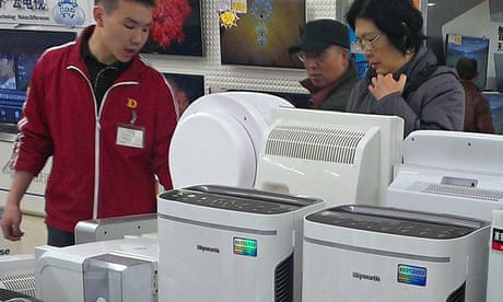 Customers shop for air purifier at an appliance store in Beijing, China