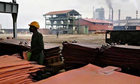 MDG : Glencore in Zambia :  worker stacks copper plates at Mopani Copper Mine Plc's Mu