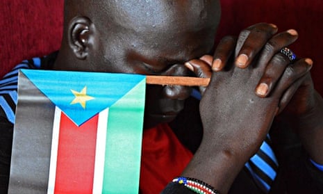 MDG : South Sudan : A man holds a South sudan flag