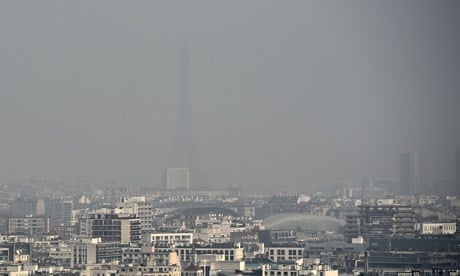 Eiffel tower and Paris' roofs through a haze of pollution