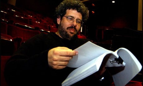 Neil LaBute reads a script in an empty theatre auditorium