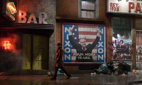 Rorschach from the Watchmen walking past a poster of Richard Nixon
