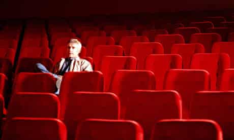 Man Sitting Alone In Empty Cinema
