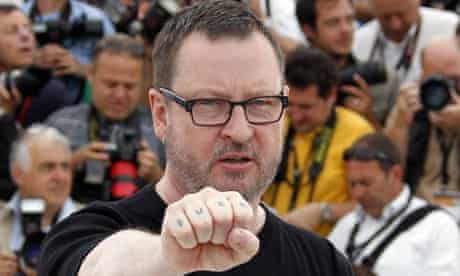 Lars Von Trier shows his tattoo during the photocall of Melancholia