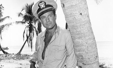 Cliff Robertson as JFK leaning nonchalantly against a palm tree