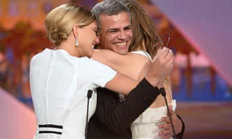 Lea Seydoux (left) and Adele Exarchopoulos embrace director Abdellatif Kechiche