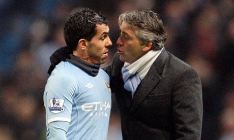 The Manchester City manager Roberto Mancini and Carlos Tevez