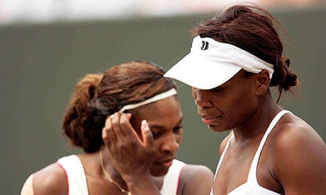 Serena, left, and Venus Williams during their doubles defeat to Elena Vesnina and Vera Zvonareva
 