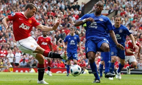 Manchester United's Michael Owen shoots past Everton's Sylvain Distin at Old Trafford