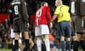 Wayne Rooney has words with referee Duhamel Laurent.
